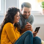 Wife and Husband Looking at Mobile Phone